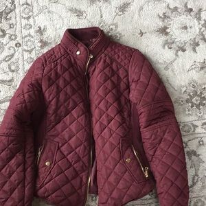 A maroon coat with pockets